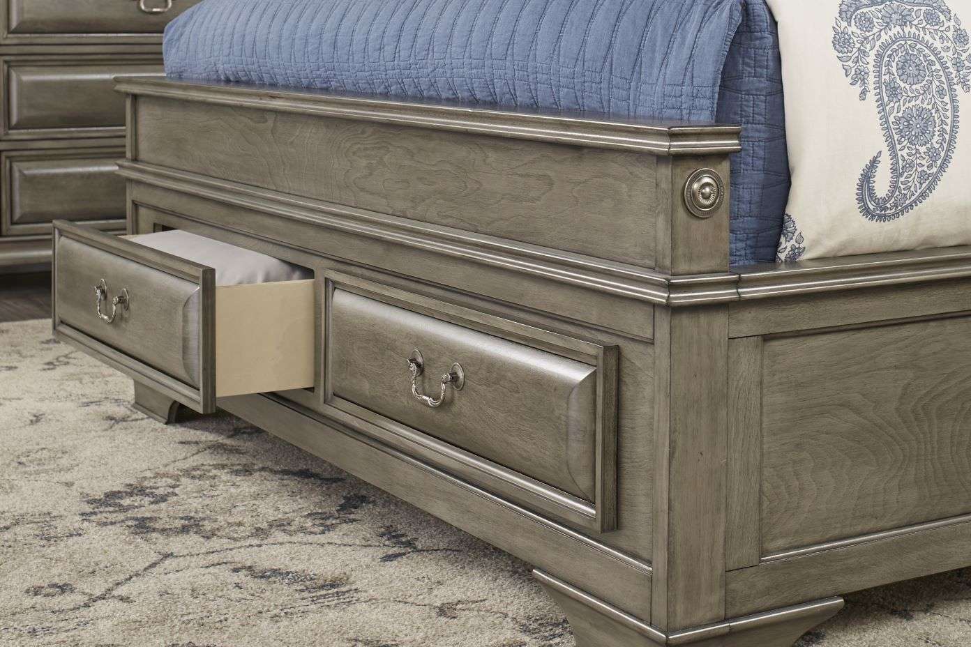 Gray wooden bed frame with drawers.
