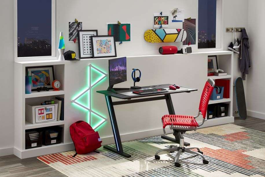Gaming desk with a red chair, headphones, and a computer monitor.
