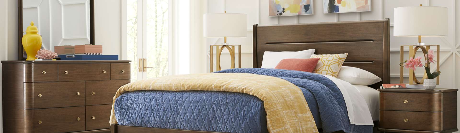 Bedroom furniture set with a bed, dresser, and nightstand.
