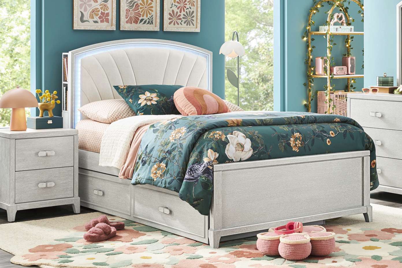 Bedroom with a bed, nightstand, and floral rug.