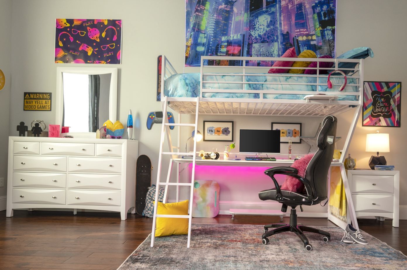 A bedroom with a loft bed, desk, and gaming chair.
