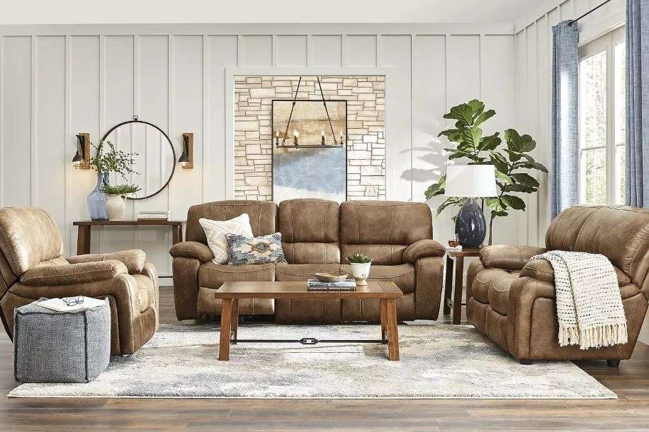 A living room with brown leather furniture, a rug, and a coffee table.