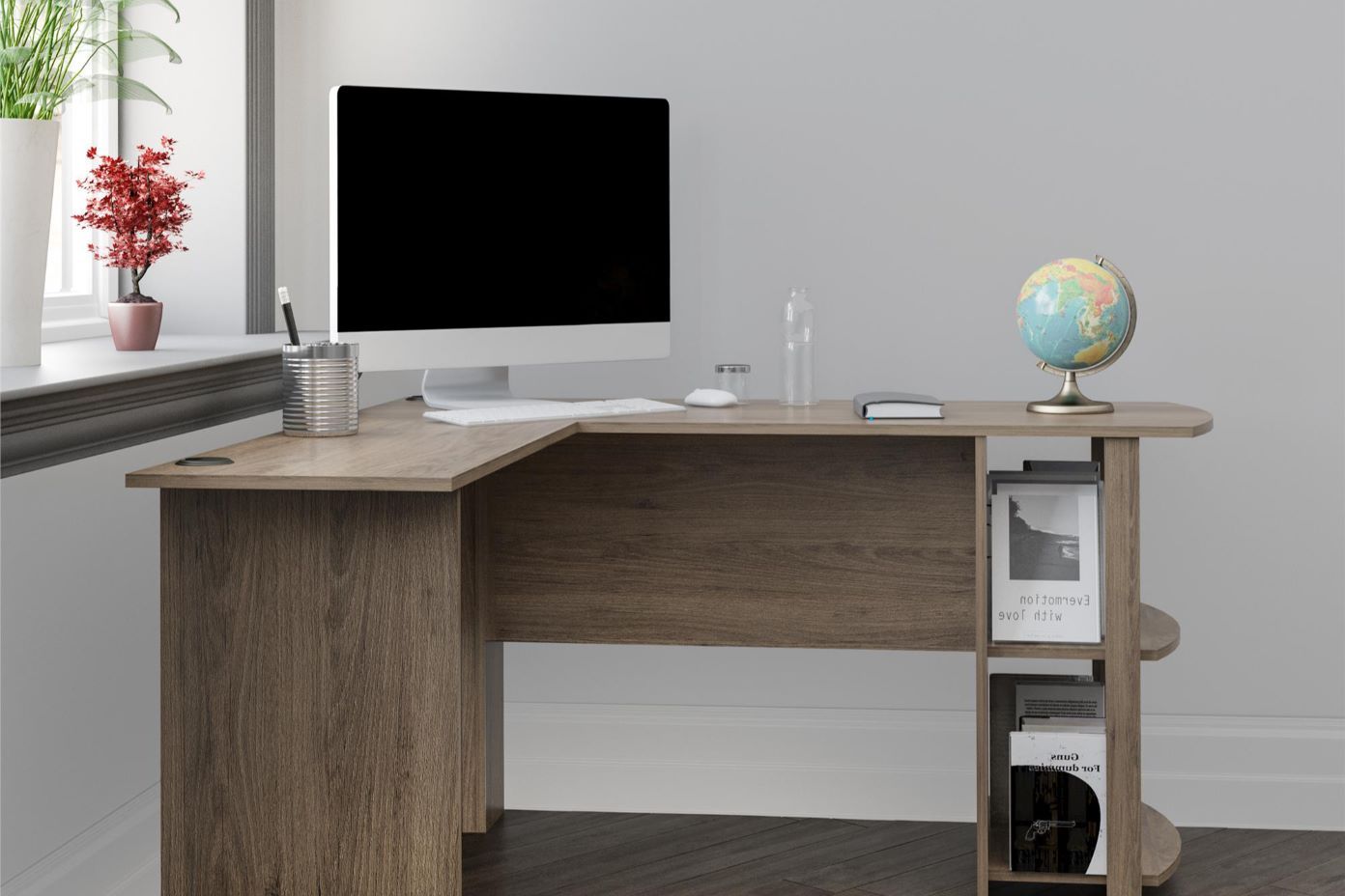 L-shaped wooden desk with a computer, globe, and books.
