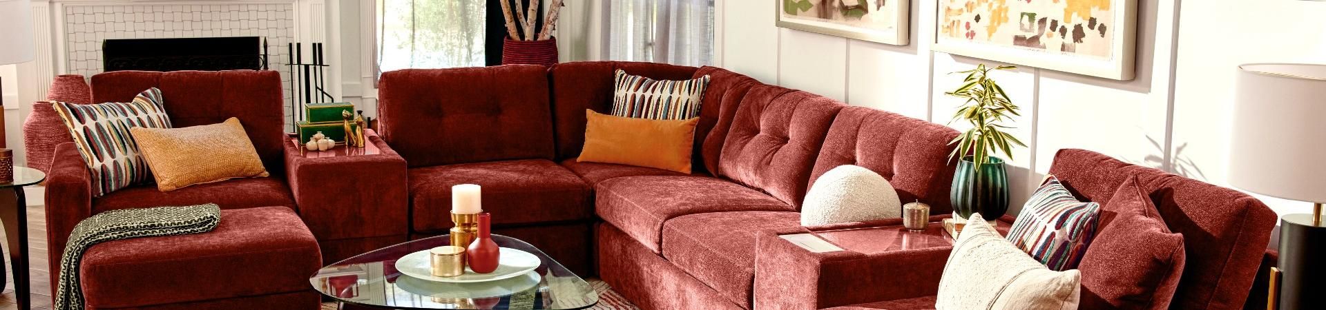 Red sectional sofa with decorative pillows.
