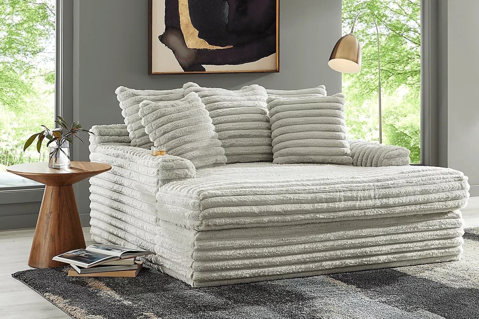 Light gray corduroy sofa with pillows.
