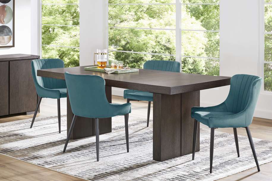 A dining room set with a dark wood table and teal chairs.