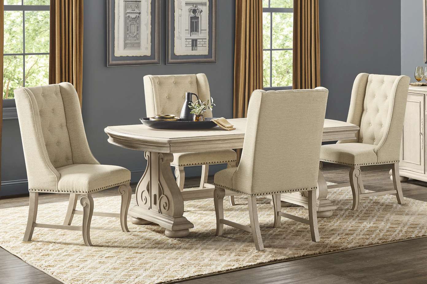 Dining room set with a table and four upholstered chairs.
