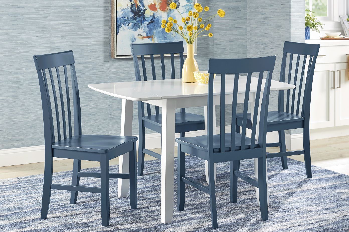 A dining table with four blue chairs.
