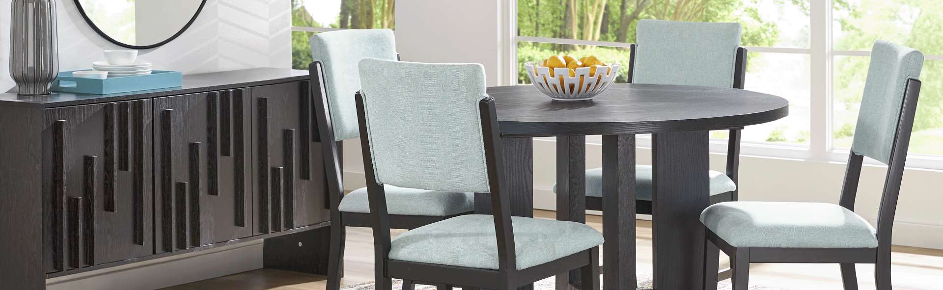 Dining room set with a round table and four chairs.