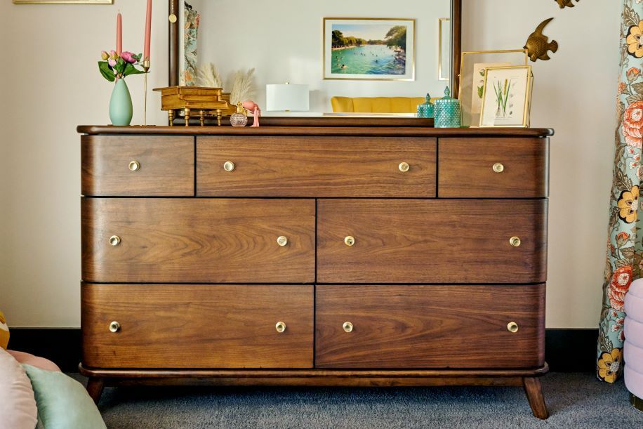 Wooden dresser with brass knobs.
