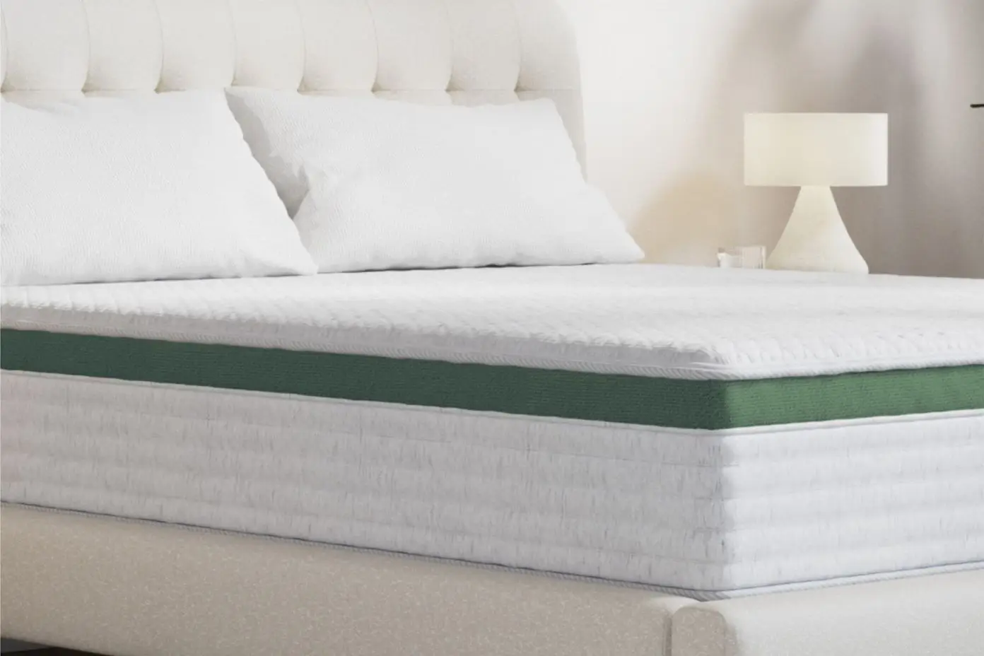 Mattress with white pillows and a green side.
