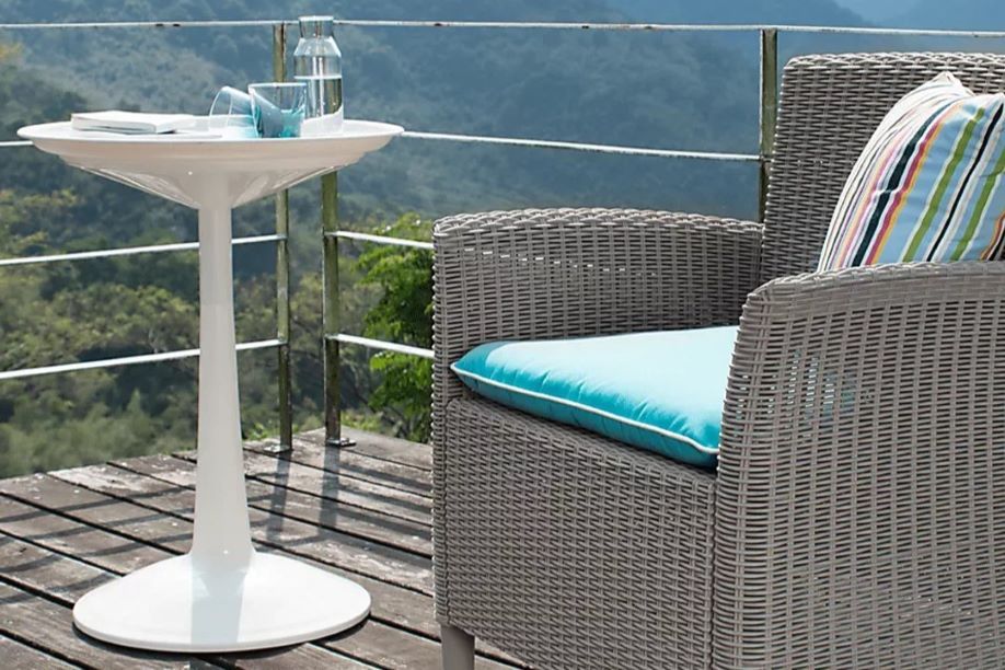 white table with brown chair and blue cushions