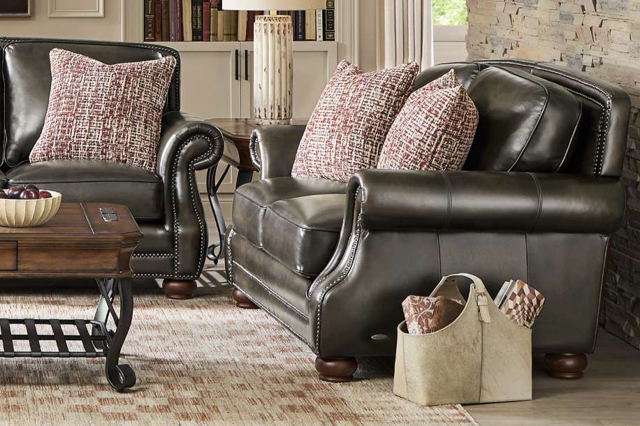Leather armchairs with patterned pillows.
