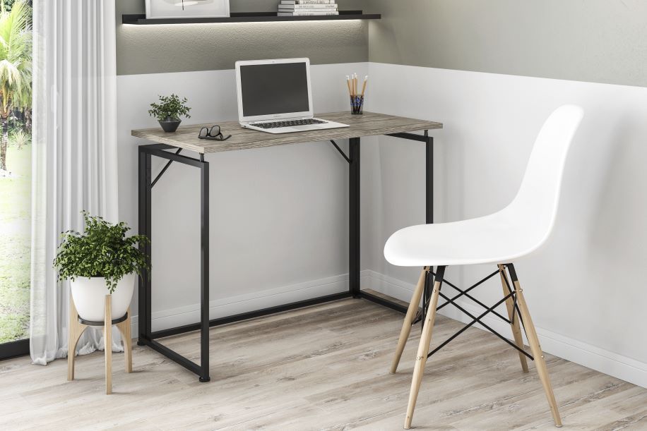 A modern desk with a laptop, a white chair, and a potted plant.
