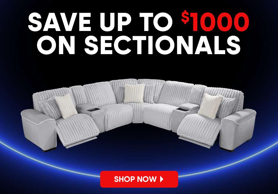 SAVE UP TO $1000 ON SECTIONALS. A light gray sectional sofa with white pillows.