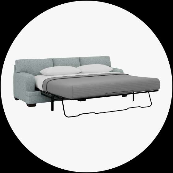 Light blue sofa bed with a gray blanket and two white pillows.
