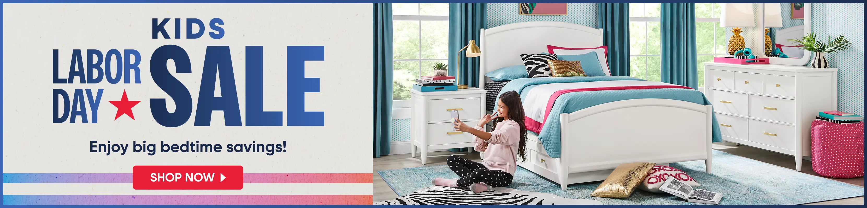 KIDS LABOR DAY SALE: Enjoy big bedtime savings! Shop now. A girl sits on a rug in a bedroom with white furniture.