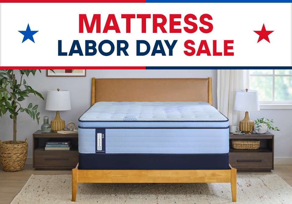 MATTRESS LABOR DAY SALE. A blue mattress on a wooden bed frame.
