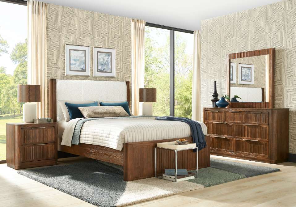 Bedroom furniture set with a bed, nightstand, dresser, and mirror.
