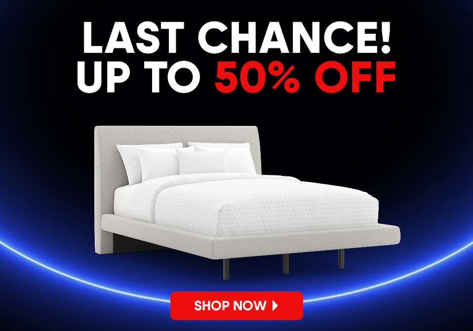 LAST CHANCE! UP TO 50% OFF. A bed with white bedding.