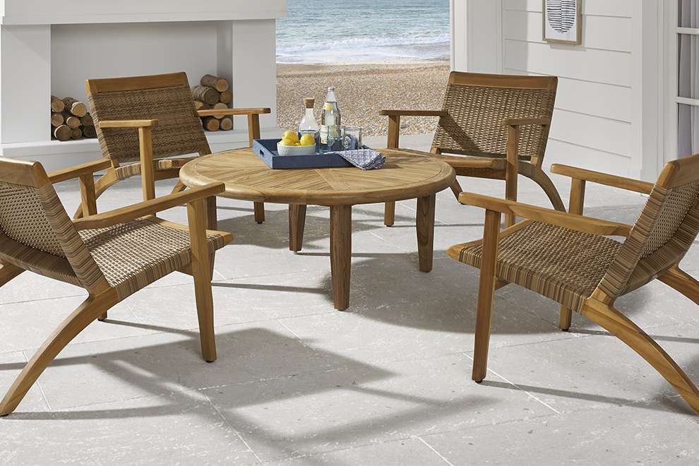 Outdoor furniture set with a round table and four chairs.
