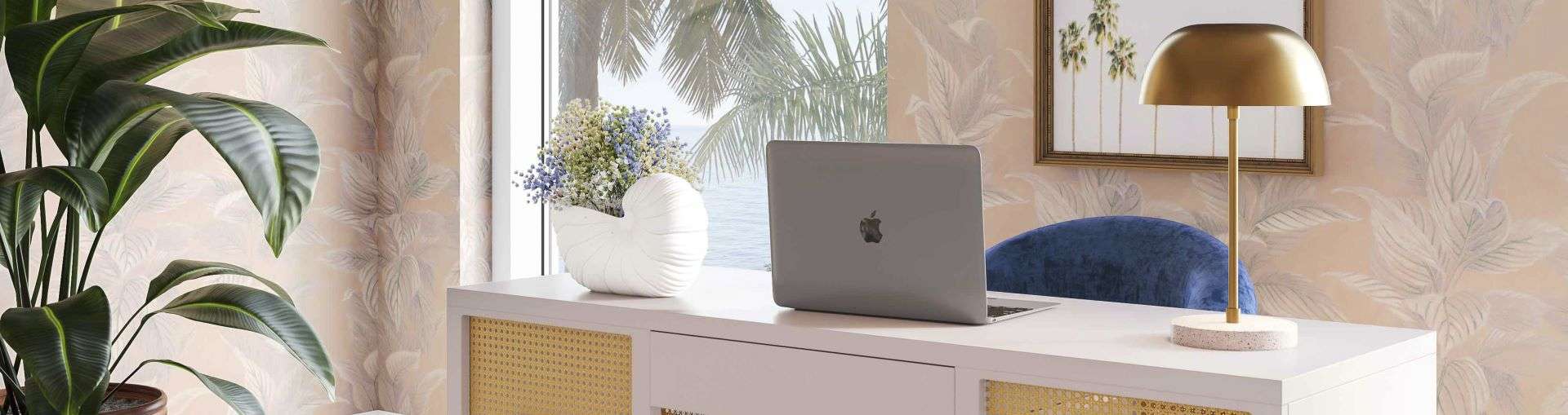 A modern desk with a laptop, lamp, and a vase of flowers.