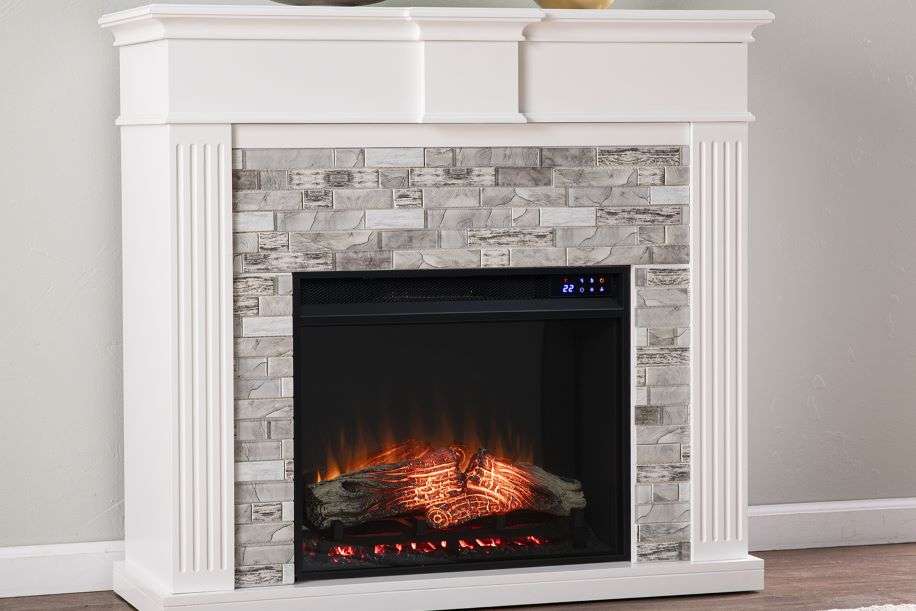 White electric fireplace with gray brick-like tile surround and a digital display.
