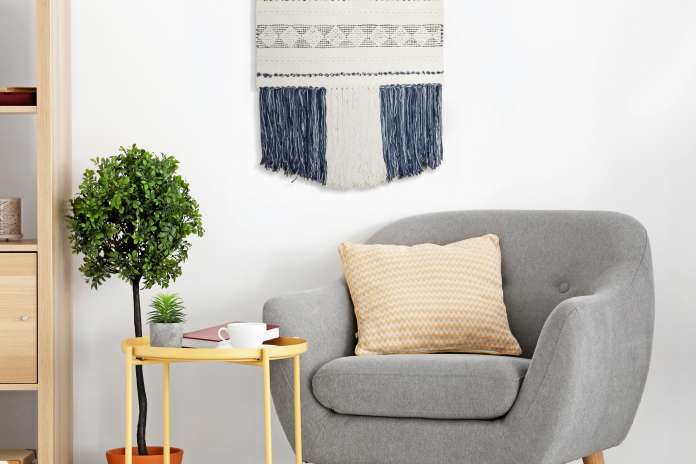 gray chair and boho wall art