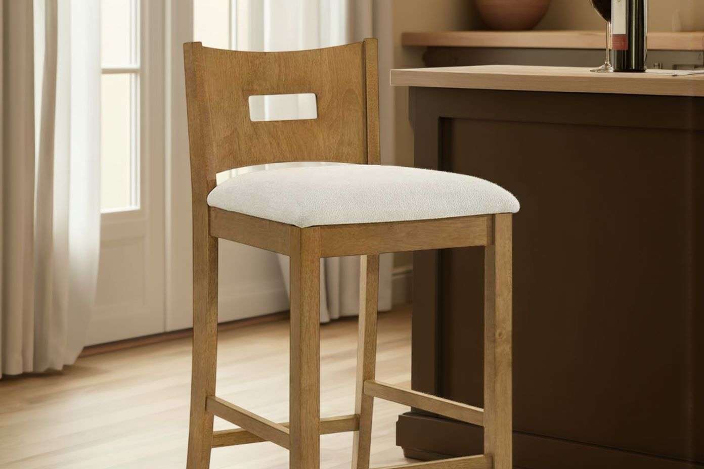 Wooden bar stool with a white cushioned seat.
