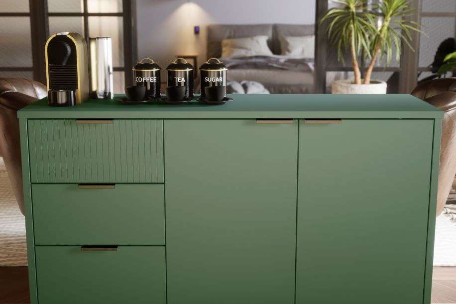 Green cabinet with drawers and doors, holding coffee, tea, and sugar canisters.
