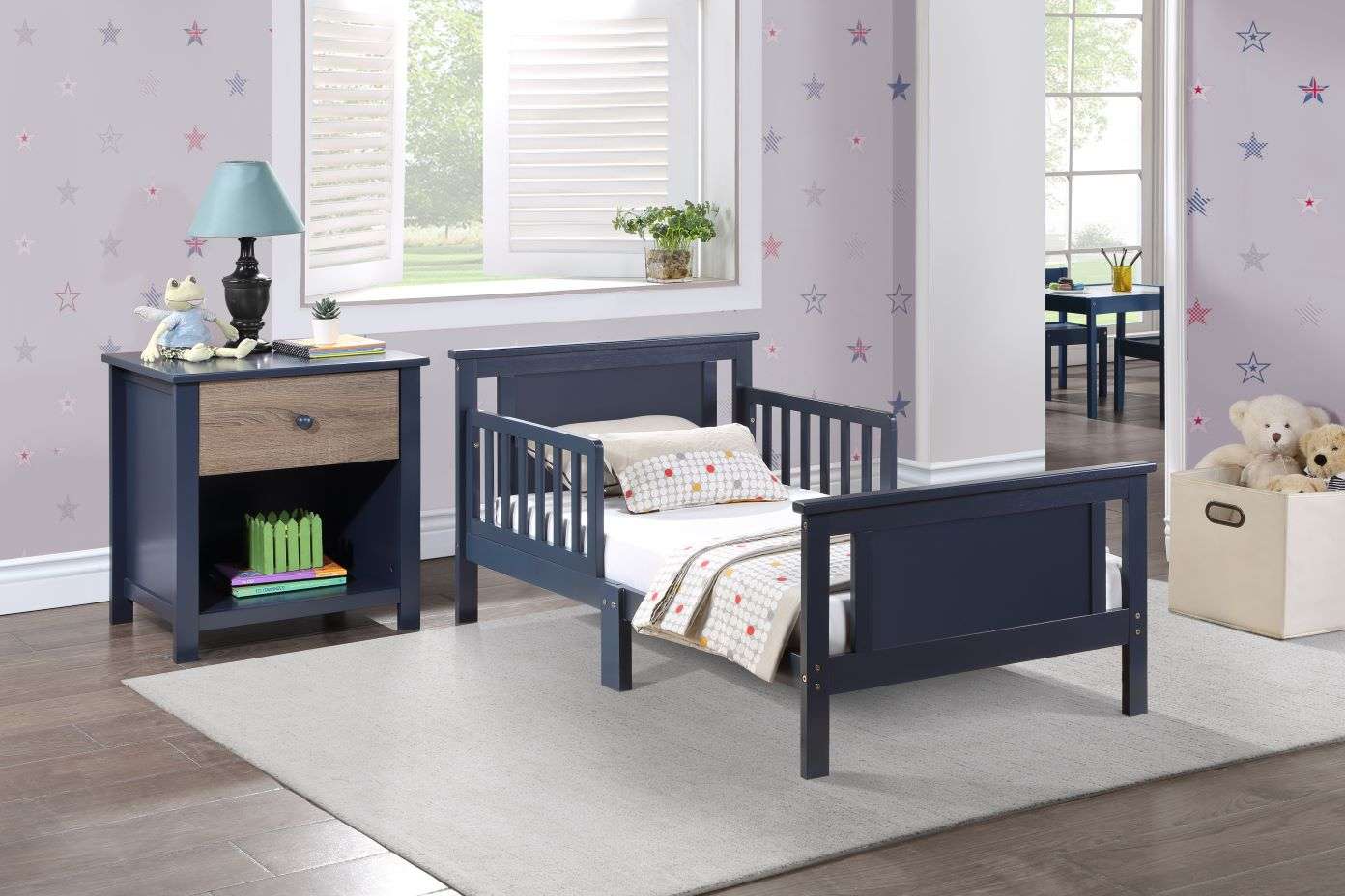 A navy blue toddler bed with a matching nightstand in a child's bedroom.