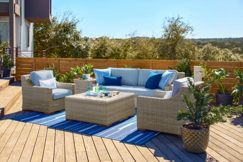 Outdoor patio furniture set on a wooden deck.
