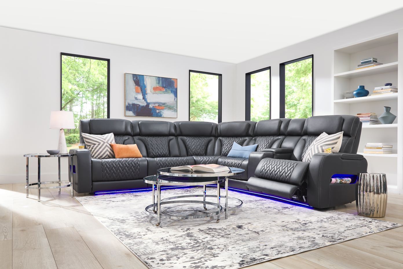 Black leather sectional sofa with blue LED lighting.
